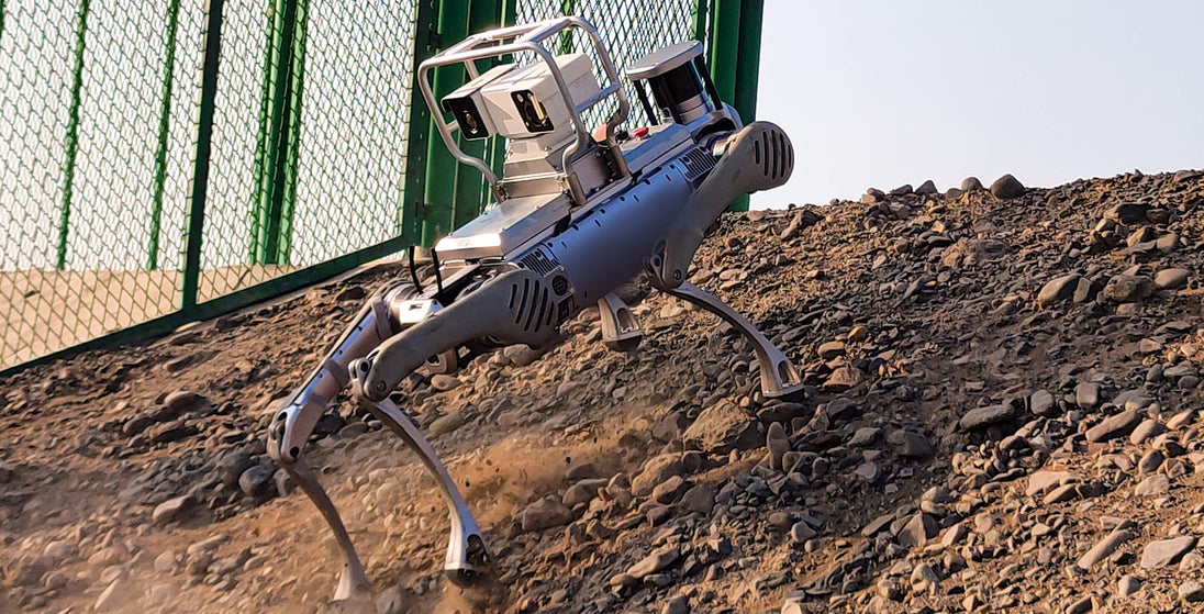 Unitree B2-XJ2-B inspection robot with protective roll cage, dual-light PTZ camera and LiDAR climbing a rubble slope