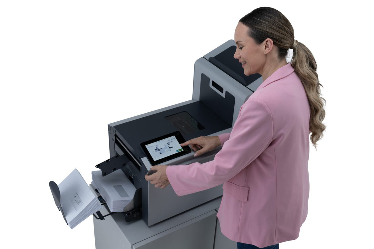 Office worker operating the Intimus TSI-4G folder inserter