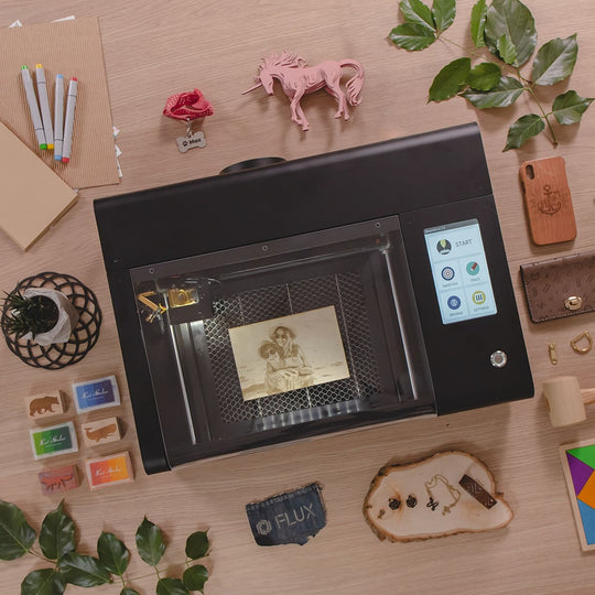FLUX beamo compact laser cutter on a desk showing its small footprint