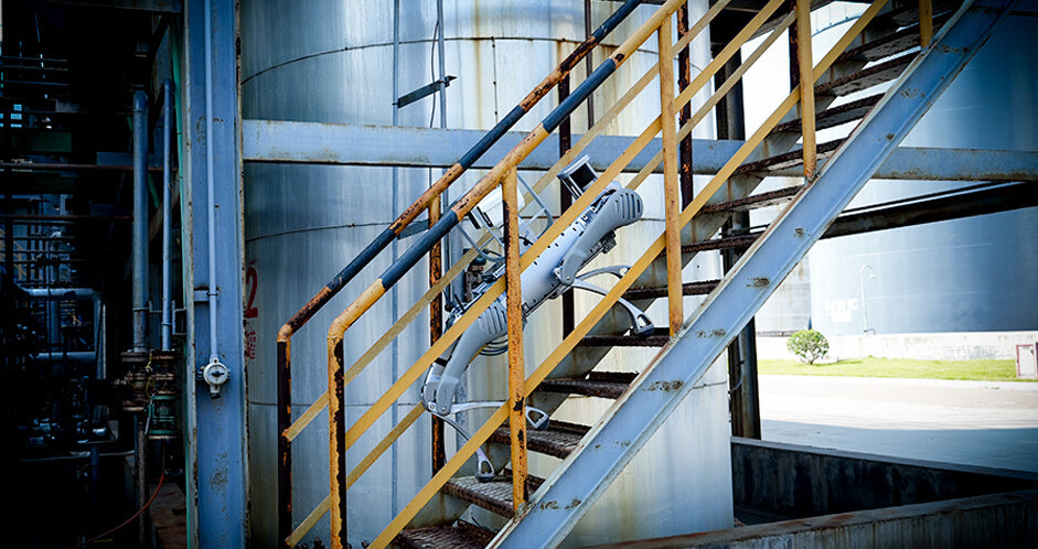 Unitree B2 quadruped robot performing autonomous power/industrial inspection on an industrial staircase