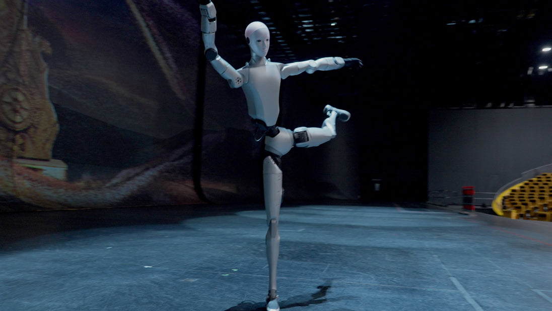 Unitree H2 Humanoid Robot performing a dynamic balance pose on stage, full-body action shot