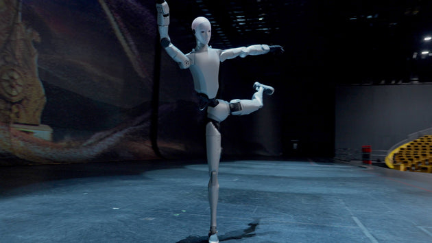 Unitree H2 Humanoid Robot performing a dynamic balance pose on stage, full-body action shot